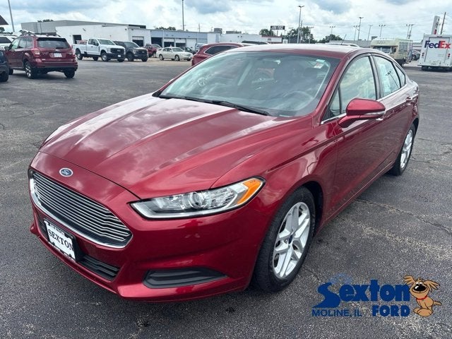 2016 Ford Fusion SE in Ruby Red Metallic Tinted Clearcoat — front three-quarter view